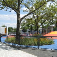 Schmul Park playground features colorful play structures and abundant greenery.