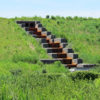  Stormwater is collected via a network of stormwater swales, channels, and downchutes which convey the water to holding basins at the base of the mounds.